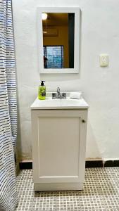 a bathroom with a white sink and a mirror at DGM Lofts MTY MN 960 D centro cerca de todo in Monterrey +15 photos