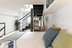 a bedroom with a large bed and a staircase at The Naxos Loft with view of the Castle in Naxos Chora