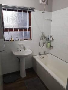 a bathroom with a sink and a tub and a sink and a toilet at SHALOM in Margate