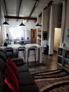 a living room with a couch and a kitchen at SHALOM in Margate