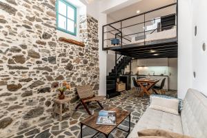 a living room with a stone wall at The Naxos Loft with view of the Castle in Naxos Chora