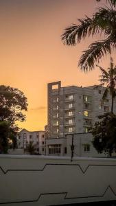 a large building with palm trees in front of it at Meshaal heights in Mombasa