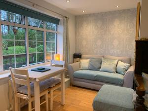 a living room with a couch and a table at The Lady of the Lake Windermere in Windermere