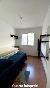 a bedroom with two beds and a window at Apartamento 2 quartos completo com garagem in Juiz de Fora