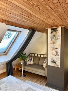 a living room with a couch and a window at Altja Villa-Cottage with sauna in Altja