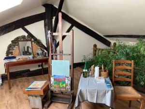 a room with a table with a cross on it at Maison Les Beaux Arts in Mouzay