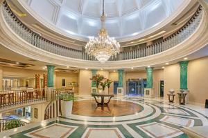 a large lobby with a domed ceiling and a chandelier at Dobedan Beach Resort Comfort ''Ex Brand Alva Donna Beach Resort Comfort'' in Side