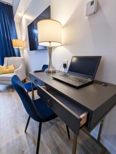 a laptop computer sitting on a desk in a room at LE LOFT BLEU - Centre-Ville de Québec in Quebec City