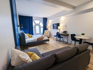 a living room with a couch and a room with a bed at LE LOFT BLEU - Centre-Ville de Québec in Quebec City +9 photos