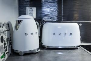 two toasters sitting next to each other on a counter at Nordic Design Apartment City Center in Rovaniemi +14 photos