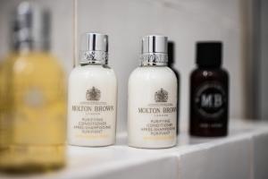 three bottles of hair products sitting on a shelf at The Nook in Athens