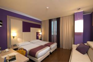 A bed or beds in a room at AS Hotel Limbiate Fiera