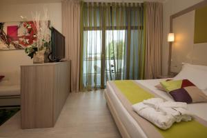 A bed or beds in a room at AS Hotel Limbiate Fiera