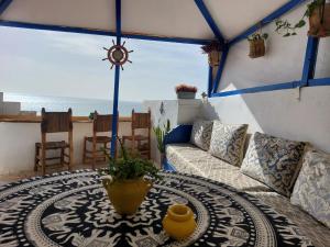 a living room with a couch and a table at Asala Guest House in Taghazout
