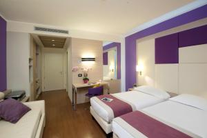 A bed or beds in a room at AS Hotel Limbiate Fiera