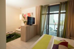 A bed or beds in a room at AS Hotel Limbiate Fiera