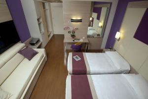 A bed or beds in a room at AS Hotel Limbiate Fiera