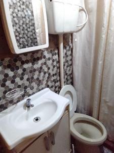 a bathroom with a sink and a toilet at Macrigaluma Sol in Barra del Chuy