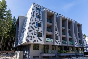 a building with a geometric design on it at Bjelasnica A6 in Bjelašnica