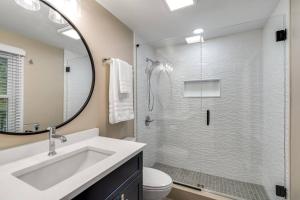 a bathroom with a sink and a shower with a mirror at Riverside Retreat! in West Lafayette +36 photos