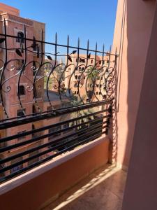 a balcony with a wrought iron railing on a building at Lala's apartment in Marrakesh