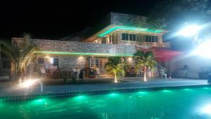 a house with a swimming pool at night at @BeachHouseItamaraca in Itamaracá