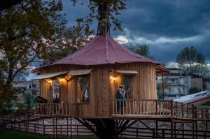a man is standing in a tree house at Panos House - Warm and cozy retreat in Tríkala