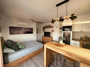 a living room with a bed and a table in it at Sunrisemare Vacational Studio in Roses