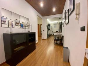 a living room with a black cabinet and a table at Gaslini and beaches two steps away in Genova