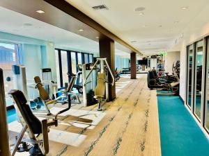 a gym with treadmills and exercise equipment in a building at The Clouds in Los Angeles