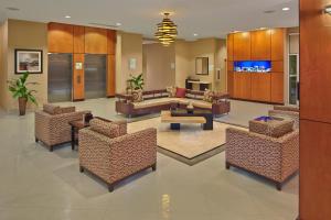 a lobby with chairs and a couch and a table at Holiday Inn Jacksonville E 295 Baymeadows, an IHG Hotel in Jacksonville