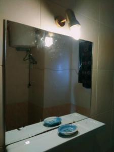 a mirror with two plates on a counter in a bathroom at Shared room with the owner only at the Delta Hotel and Resort Sharm El Sheikh in Sharm El Sheikh