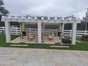 a white gazebo with chairs and a table at Hermosa Casa de Campo in Palomas