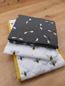 a group of three sheets with bees on them at Bee Happy Apartament Wrzesnia ll in Września