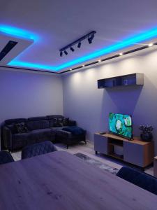 a living room with blue lights on the ceiling at Bee Happy Apartament Wrzesnia ll in Września