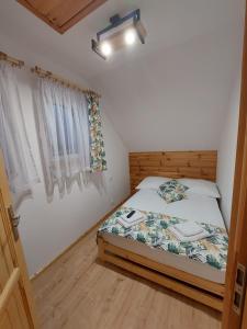 niewielka sypialnia z łóżkiem i oknem w obiekcie Skalne Rancho w mieście Rabka-Zdroj