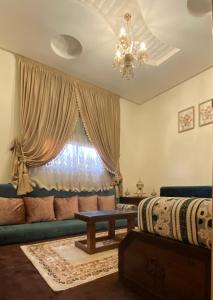 a living room with a couch and a window at Luxurious Family Holiday Home in Temara