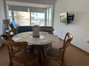 a dining table and chairs in a living room at Club del Mar in Punta del Este