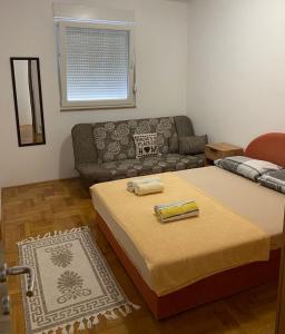 a living room with two beds and a couch at Apartman CENTAR in Trebinje