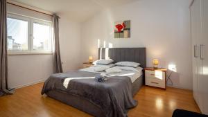 a bedroom with a large bed and a window at Apartments Luka free bikes in Rovinj