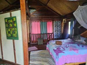 a bedroom with a bed in a room with windows at Chalet Avea in Parea