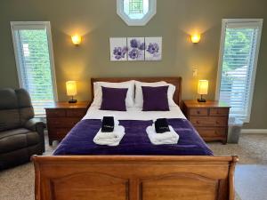 a bedroom with a bed with two pairs of shoes on it at River's Rest in Columbus