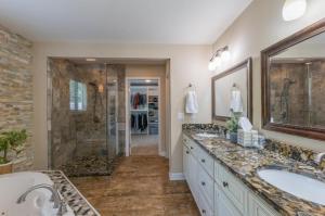 a large bathroom with two sinks and a shower at River's Rest in Columbus