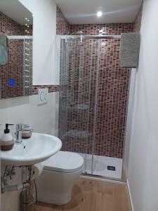 a bathroom with a shower and a toilet and a sink at Casa Donna Rosaria tra Etna e Taormina in Riposto