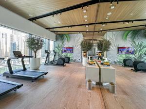 a gym with treadmills and exercise equipment in a building at Modern 2BR High Floor Haven in Vida Dubai Marina in Dubai