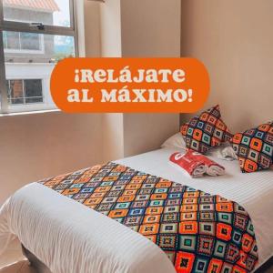 a bed with an orange sign on top of it at Hotel Tierra Santa in Santa Fe de Antioquia