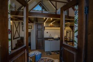 a kitchen and living room with an open door at Solomons Gray in Tangmarg