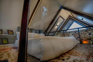 a bedroom with a large bed with a window at Solomons Gray in Tangmarg