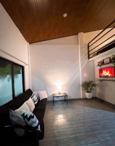 a living room with a couch and a fireplace at Cozy Loft Near the Airport & Beach-Unit I in Puerto Princesa City