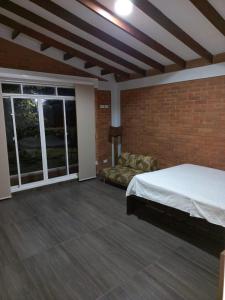 ein Schlafzimmer mit einem Bett und einem großen Fenster in der Unterkunft FINCA VILLA BLANCA in Termales + 2 Fotos